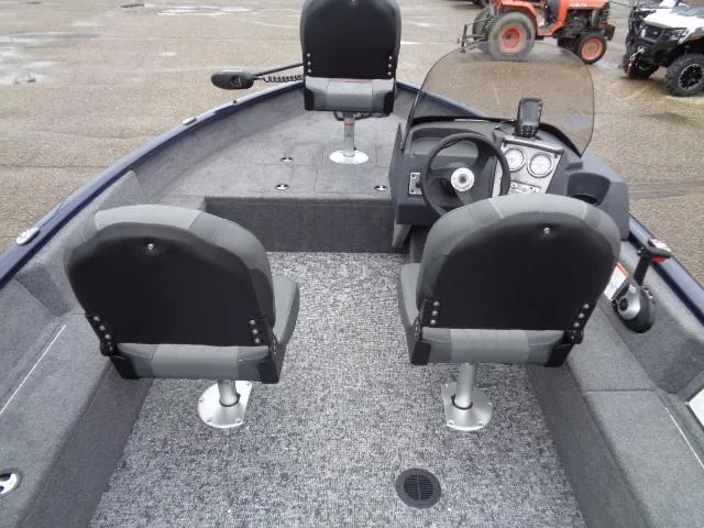 Slide: The Image of 2025 Tracker Pro Guide V-16 SC boat interior with three seats and steering console. - 5