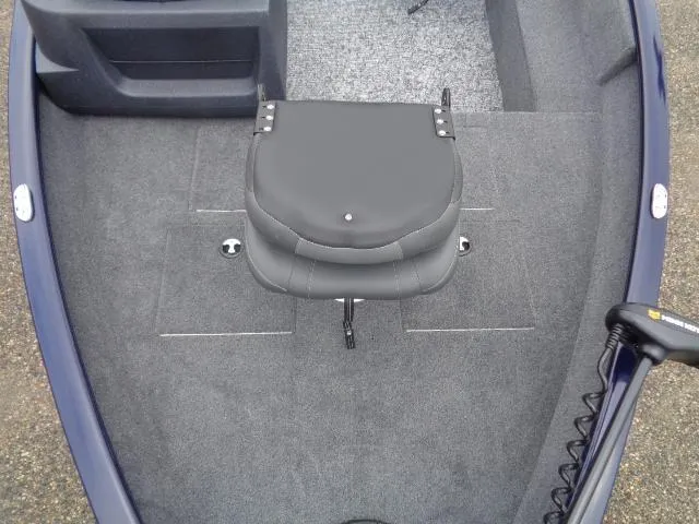 Slide: The Image of 2025 Tracker Pro Guide V-16 SC boat interior with swivel seat and carpeted floor. - 7