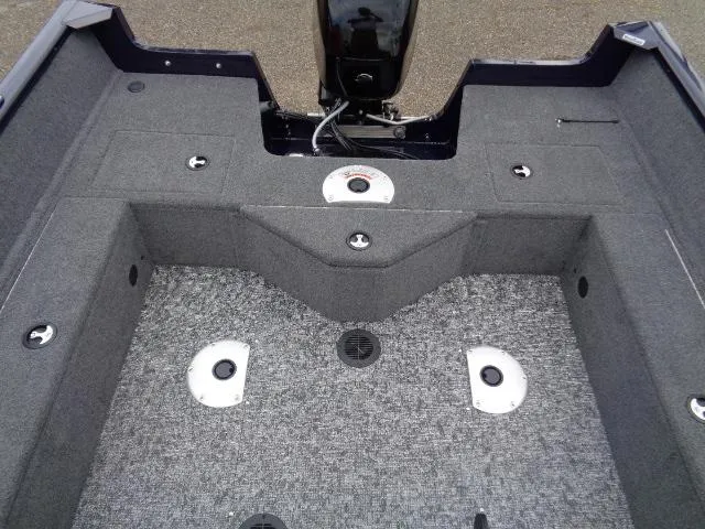 Slide: The Image of 2025 Tracker Pro Guide V-16 SC boat interior with carpeted flooring and storage compartments. - 9