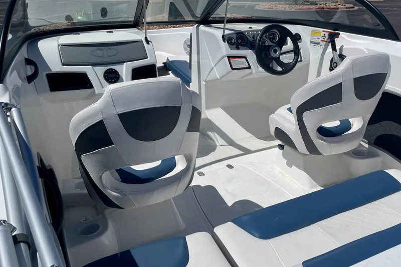 Slide: The Image of 2024 Tahoe 185 S boat interior with modern seating and dashboard design. - 2