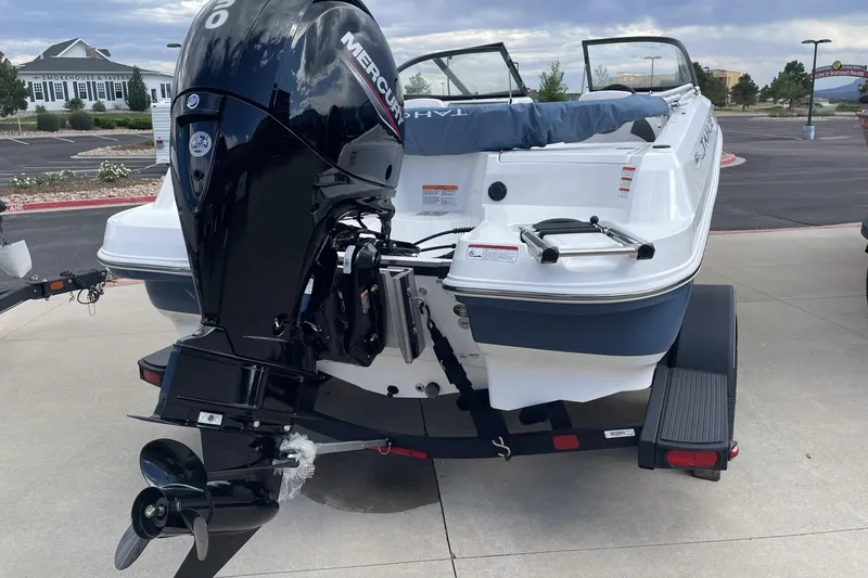 Slide: The Image of 2024 Tahoe 185 S boat with Mercury outboard motor on trailer, parked outdoors. - 4