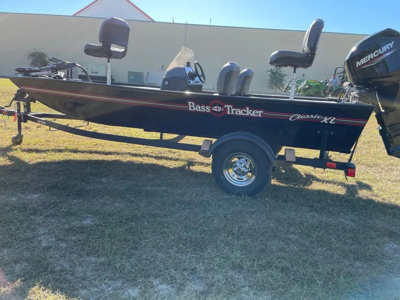 Slide: The Image of 2025 Tracker Bass Tracker Classic XL boat on trailer, side view, outdoors. - 3