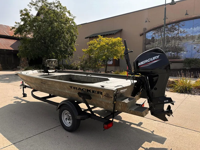 Slide: The Image of 2025 Tracker Grizzly 1654 T Sportsman boat with Mercury engine on trailer. - 2