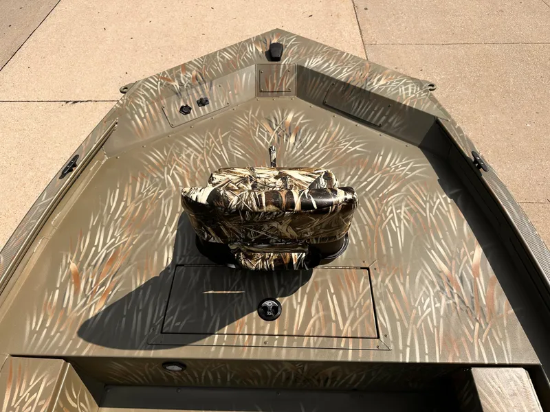 Slide: The Image of 2025 Tracker Grizzly 1654 T Sportsman boat with camouflage interior design. - 3