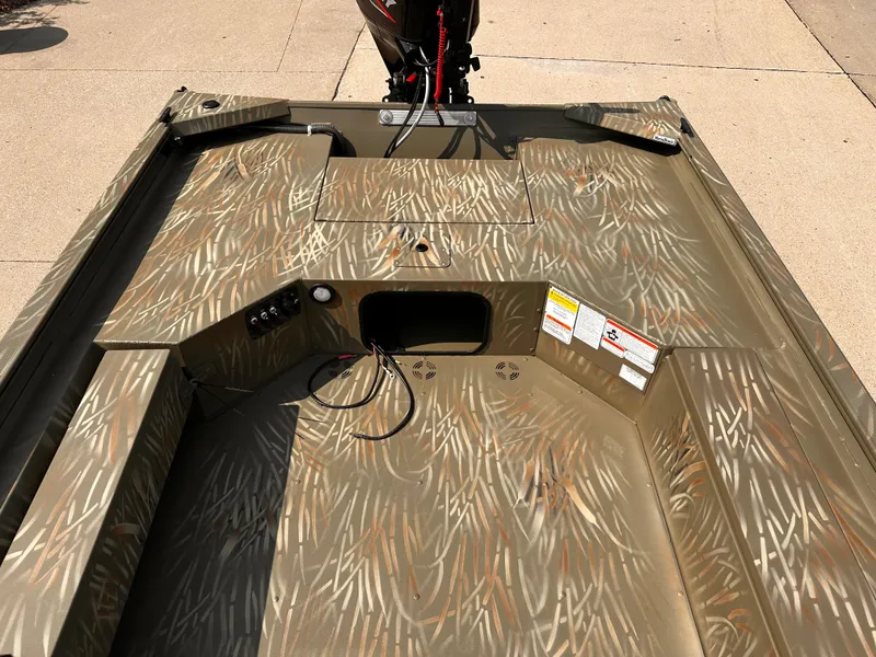 Slide: The Image of 2025 Tracker Grizzly 1654 T Sportsman boat with camo pattern interior. - 5