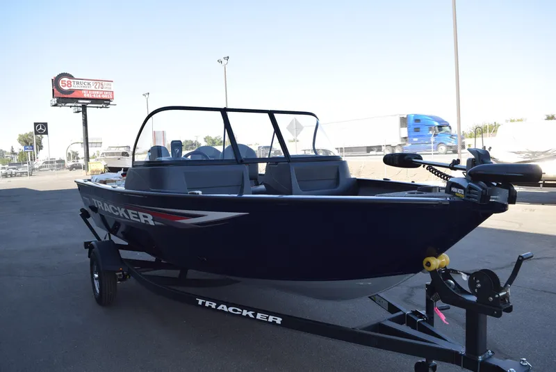 The Image of 2025 Tracker Pro Guide V-16 WT boat on trailer in parking lot. - 0
