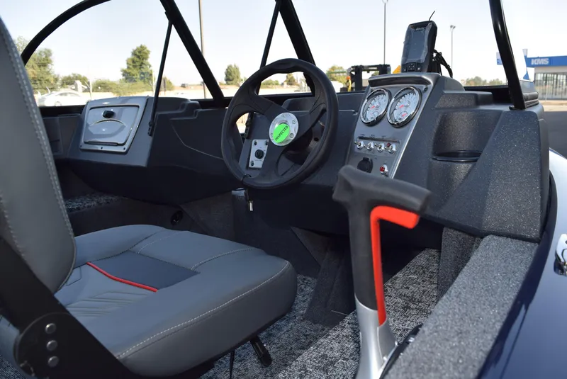 Slide: The Image of 2025 Tracker Pro Guide V-16 WT boat interior with steering wheel and dashboard controls. - 3
