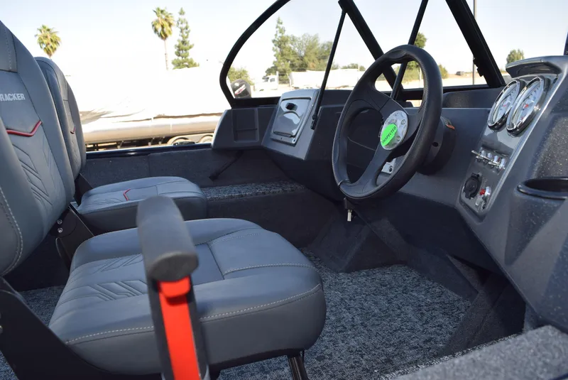 Slide: The Image of 2025 Tracker Pro Guide V-16 WT boat interior with steering wheel and seats. - 4