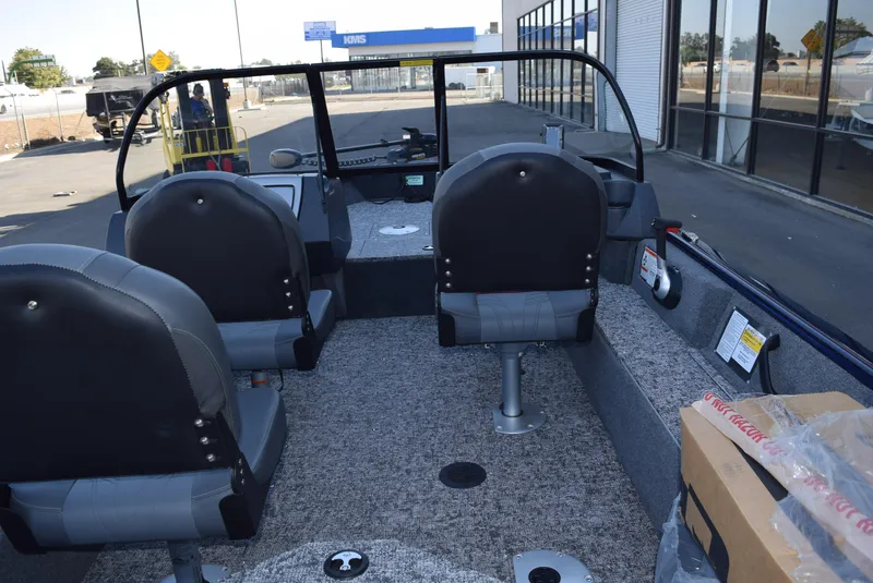 Slide: The Image of Interior of 2025 Tracker Pro Guide V-16 WT boat with seating and dashboard. - 5