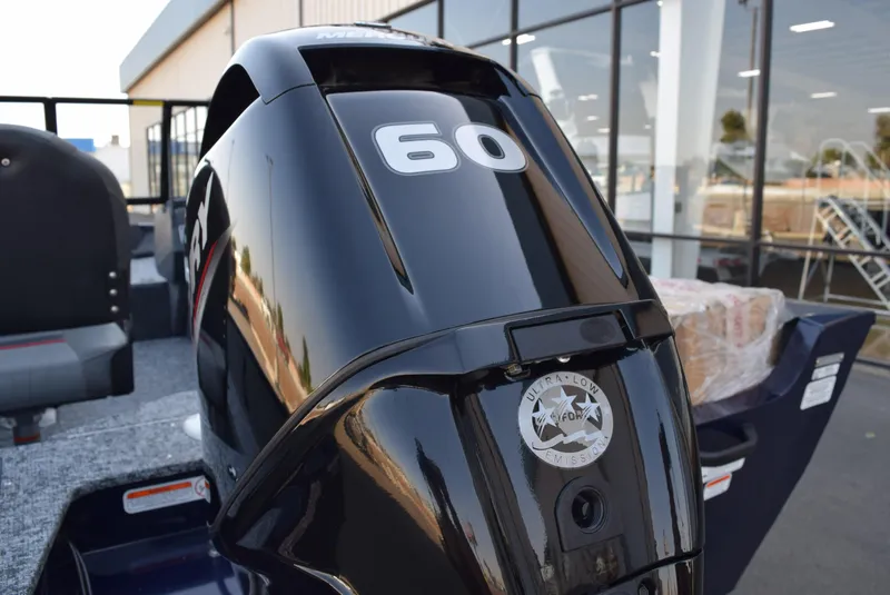 Slide: The Image of 2025 Tracker Pro Guide V-16 WT boat with 60 HP engine, outdoor showroom display. - 8