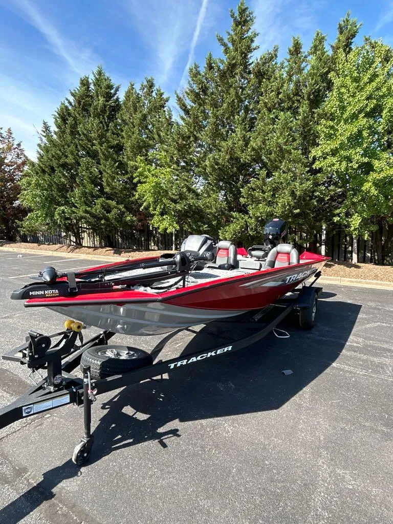 Slide: The Image of 2025 Tracker Pro Team 195 Tournament Edition boat on trailer, parked outdoors. - 3