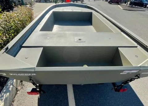 Slide: The Image of 2025 Tracker Grizzly 1754 Jon boat, empty interior, parked outdoors. - 2