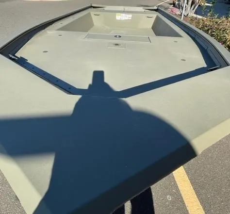 Slide: The Image of 2025 Tracker Grizzly 1754 Jon boat, olive green, parked on asphalt. - 3