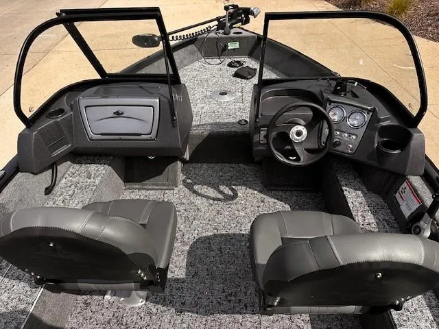 Slide: The Image of 2025 Tracker Pro Guide V-16 WT boat interior with steering console and seating. - 4