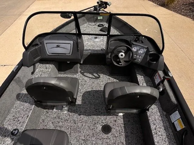 Slide: The Image of 2025 Tracker Pro Guide V-16 WT boat interior with dual seats and steering console. - 5