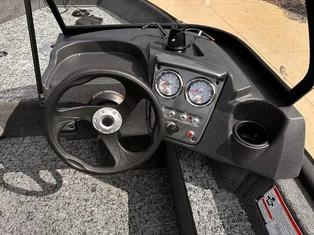 Slide: The Image of 2025 Tracker Pro Guide V-16 WT boat dashboard with steering wheel and gauges. - 6