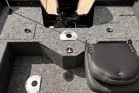 Slide: The Image of 2025 Tracker Pro Guide V-16 WT boat interior with gray carpet and seating. - 8