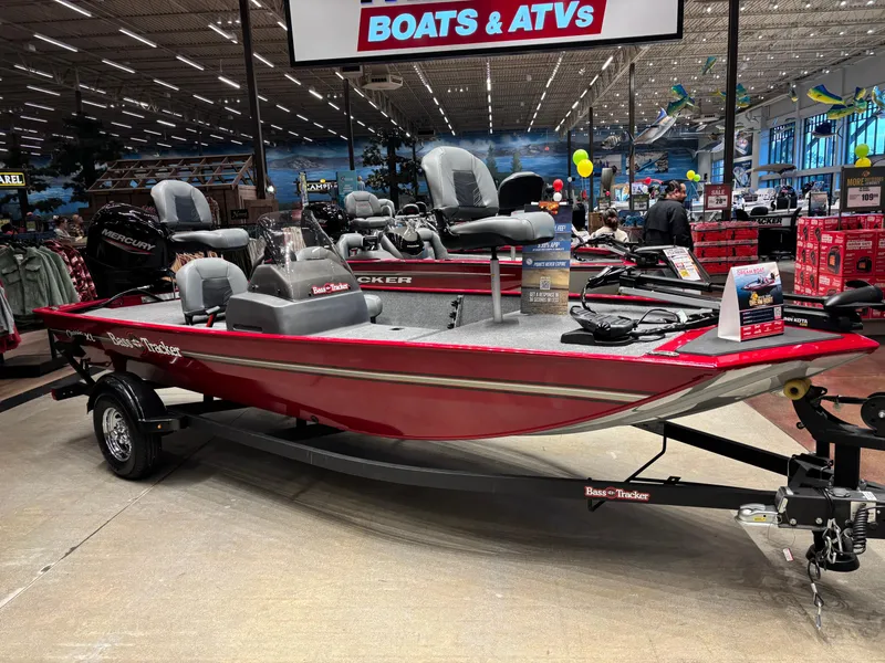 The Image of 2025 Tracker Bass Tracker Classic XL boat displayed in a showroom with ATVs. - 0