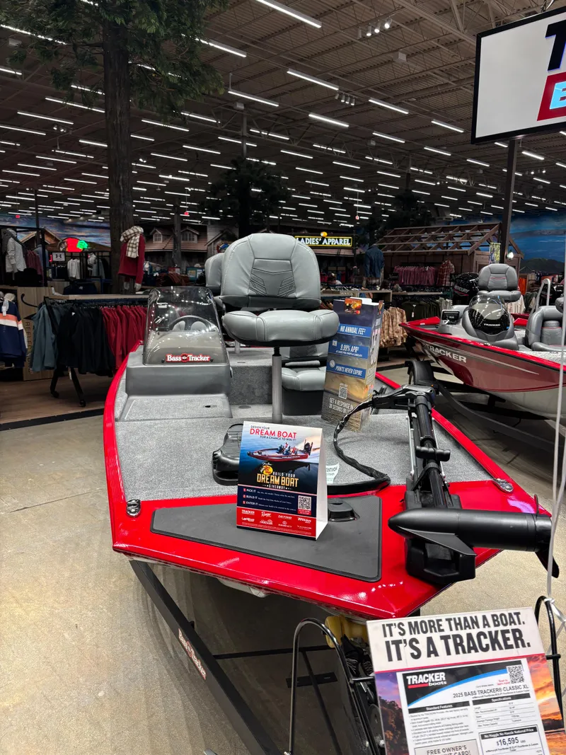 Slide: The Image of 2025 Tracker Bass Tracker Classic XL boat displayed in a showroom with promotional materials. - 3