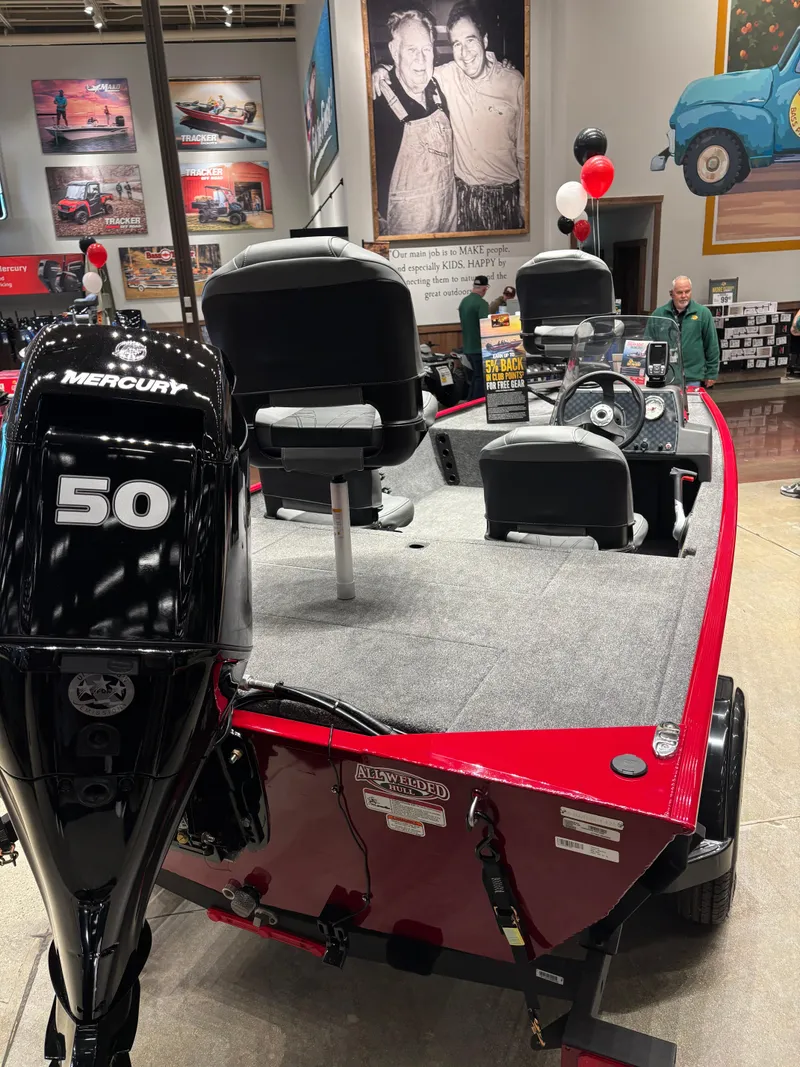 Slide: The Image of 2025 Tracker Bass Tracker Classic XL boat with Mercury 50 engine on display indoors. - 4