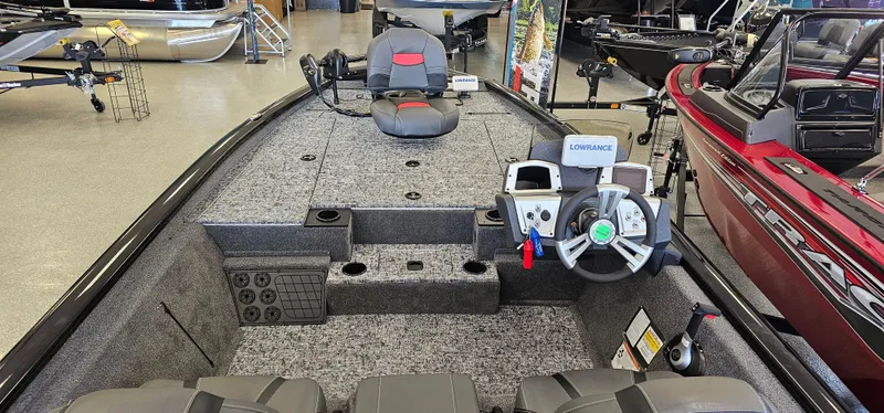 Slide: The Image of 2025 Tracker Pro Team 195 Tournament Edition boat interior with steering console and seating. - 2