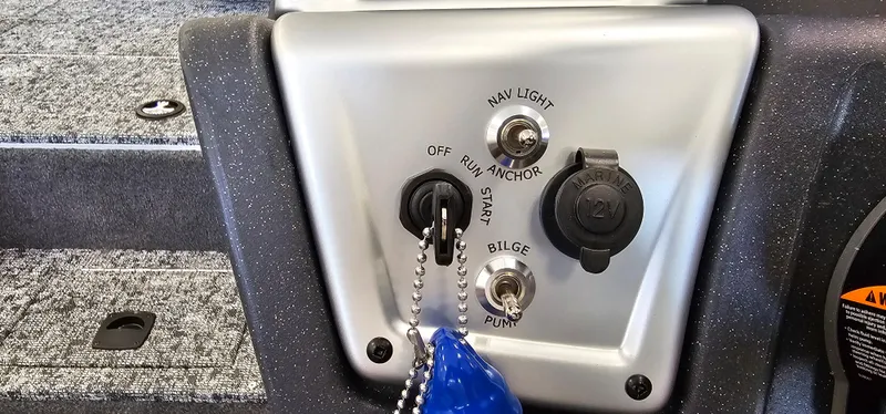 Slide: The Image of Control panel of 2025 Tracker Pro Team 195 Tournament Edition boat with key and switches. - 6