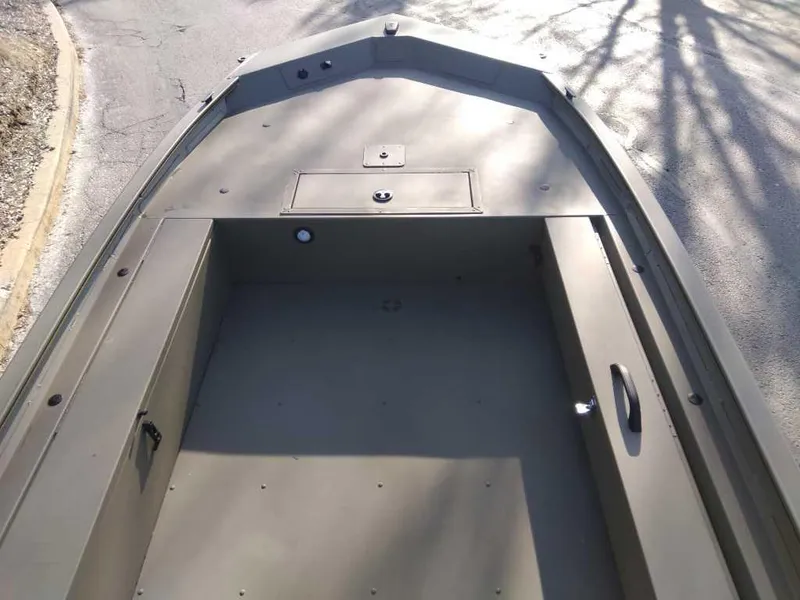 Slide: The Image of 2025 Tracker Grizzly 1654 T Sportsman boat interior, spacious and durable design. - 2