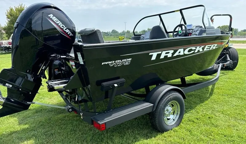 Slide: The Image of 2025 Tracker Pro Guide V-175 Combo boat on trailer, grassy background. - 5