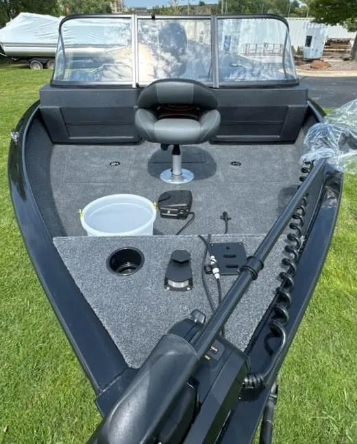 Slide: The Image of 2025 Tracker Pro Guide V-175 Combo boat interior with seating and fishing equipment. - 6