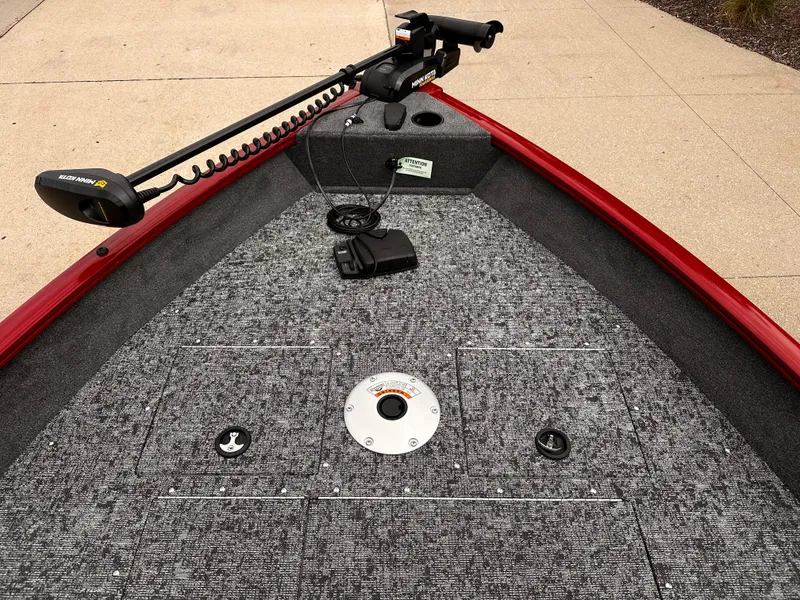 Slide: The Image of 2025 Tracker Pro Guide V-16 WT boat deck with trolling motor and carpeted surface. - 3