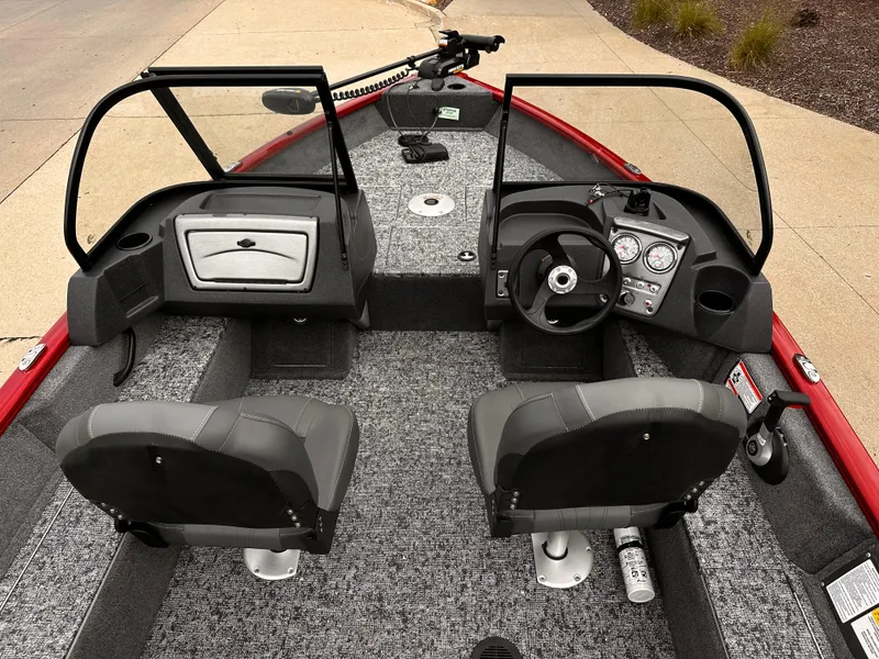 Slide: The Image of 2025 Tracker Pro Guide V-16 WT boat interior with dual seats and modern dashboard. - 4