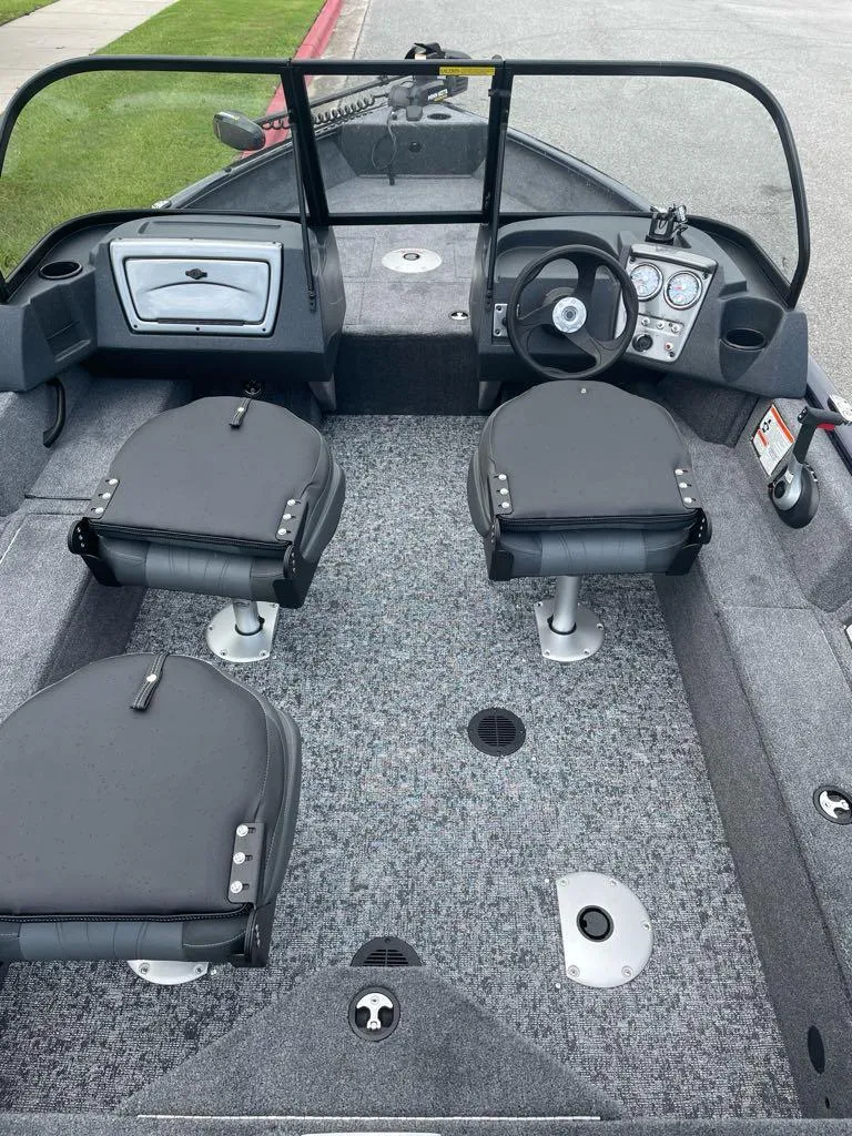 Slide: The Image of 2025 Tracker Pro Guide V-16 WT boat interior with seating and steering console. - 4