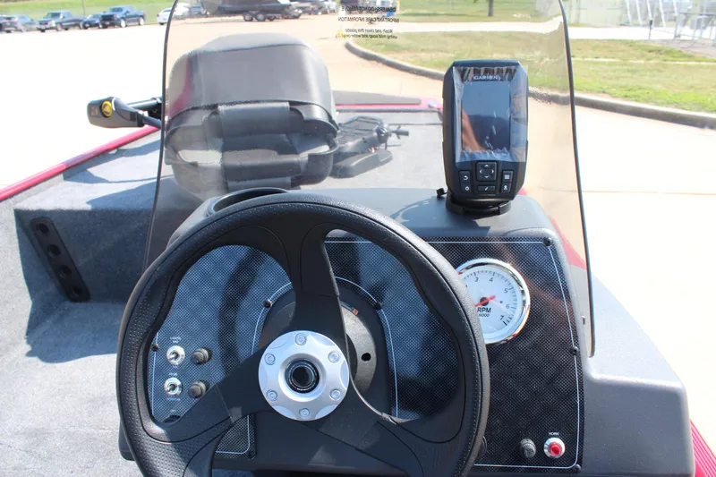 Slide: The Image of 2025 Tracker Bass Tracker Classic XL dashboard with steering wheel and fish finder. - 15