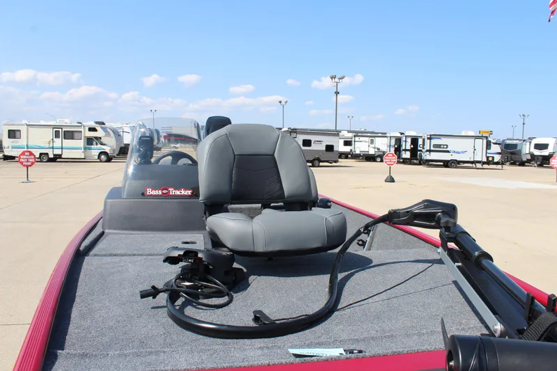 Slide: The Image of 2025 Tracker Bass Tracker Classic XL boat with gray seating and fishing equipment. - 17