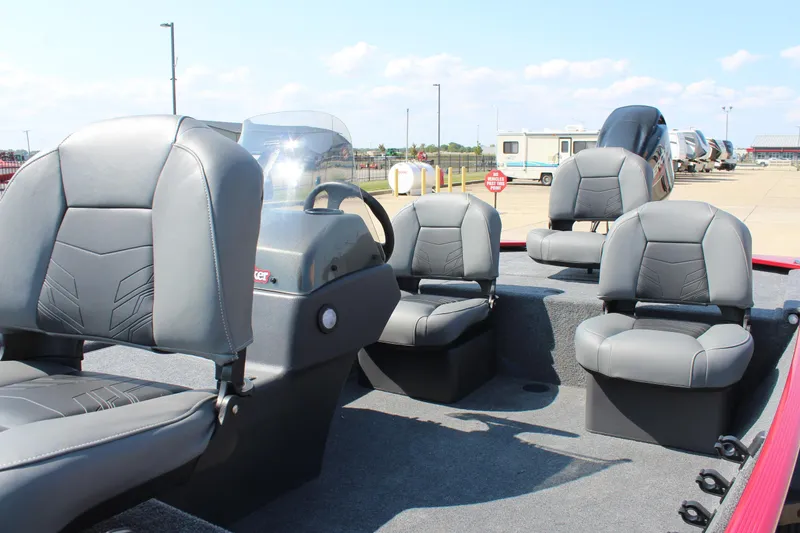 Slide: The Image of 2025 Tracker Bass Tracker Classic XL boat interior with gray seating and steering console. - 18