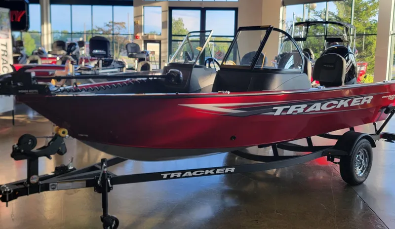 Slide: The Image of 2025 Tracker Pro Guide V-16 WT boat displayed in showroom. - 4