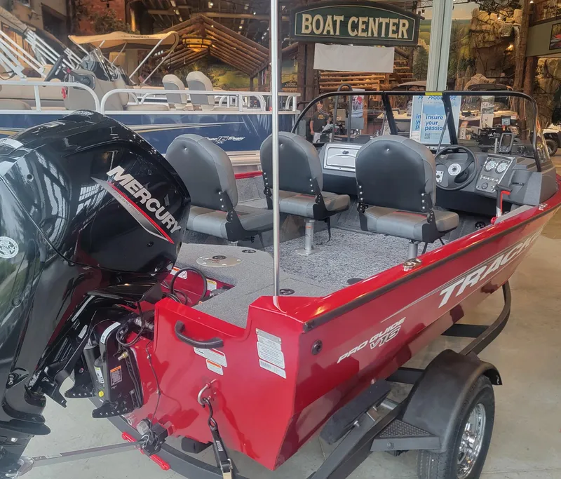 Slide: The Image of 2025 Tracker Pro Guide V-16 WT boat with Mercury engine in showroom. - 6
