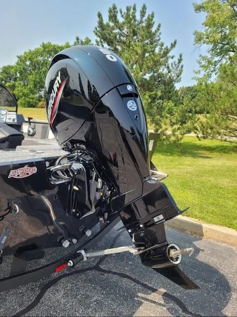 Slide: The Image of 2025 Tracker Pro Guide V-175 Combo boat with Mercury outboard motor in a sunny outdoor setting. - 2