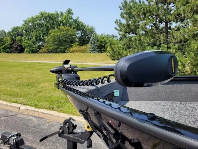 Slide: The Image of 2025 Tracker Pro Guide V-175 Combo boat with trolling motor in a scenic park setting. - 6