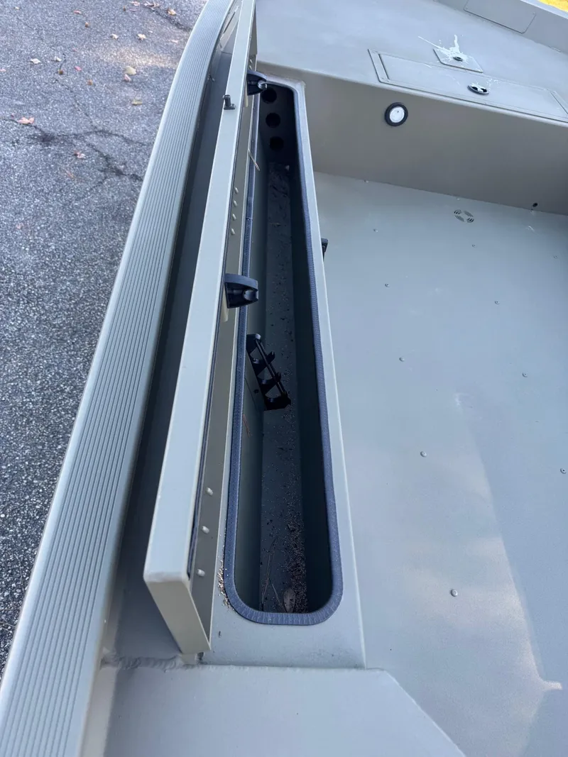 Slide: The Image of 2025 Tracker Grizzly 1654 T Sportsman boat interior with storage compartment. - 38