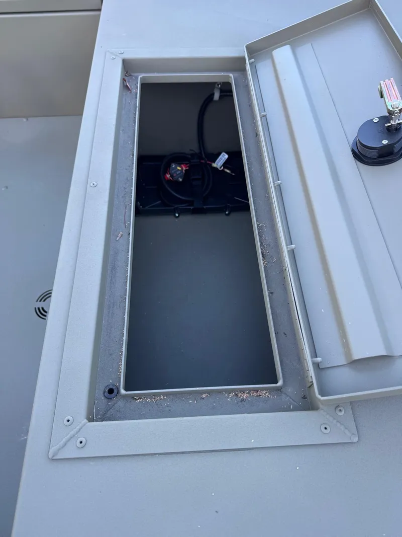 Slide: The Image of Open storage compartment of 2025 Tracker Grizzly 1654 T Sportsman boat. - 39