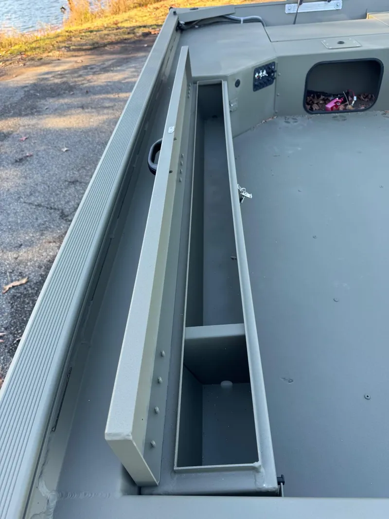 Slide: The Image of 2025 Tracker Grizzly 1654 T Sportsman boat interior with storage compartment. - 40