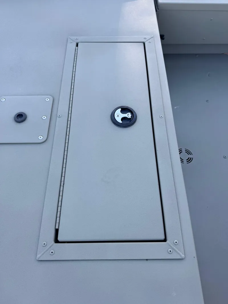 Slide: The Image of 2025 Tracker Grizzly 1654 T Sportsman boat hatch with secure latch. - 42