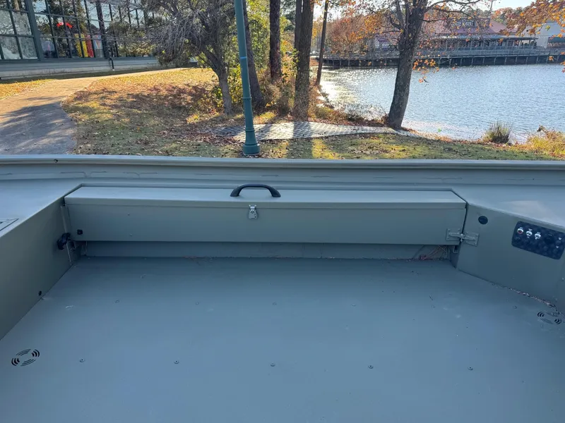 Slide: The Image of 2025 Tracker Grizzly 1654 T Sportsman boat interior by a lakeside. - 47