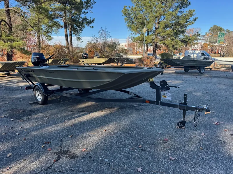 Slide: The Image of 2025 Tracker Grizzly 1654 T Sportsman boat on trailer in outdoor setting. - 49