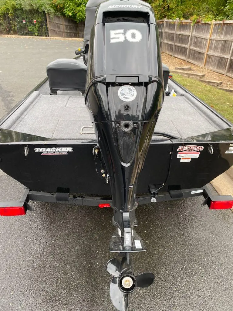 Slide: The Image of 2025 Tracker Bass Tracker Classic XL boat with 50 HP Mercury engine, rear view. - 2