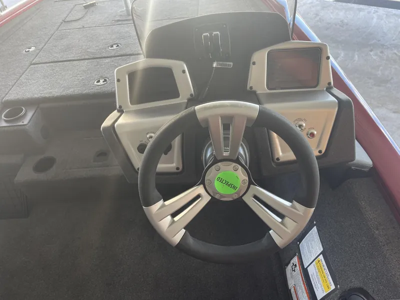 Slide: The Image of 2025 Tracker Pro Team 195 Tournament Edition boat dashboard with steering wheel and controls. - 11