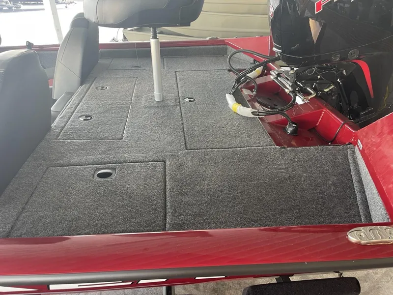 Slide: The Image of 2025 Tracker Pro Team 195 Tournament Edition boat interior with carpeted deck and motor. - 3