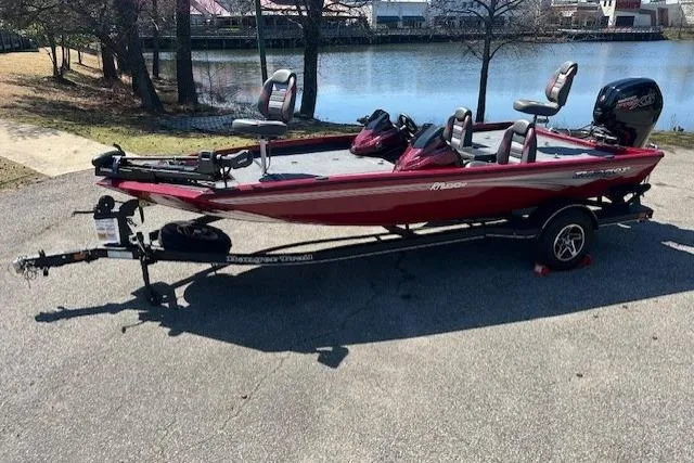 Slide: The Image of 2024 Ranger RT188P boat on trailer by a lake, featuring a sleek red design. - 6