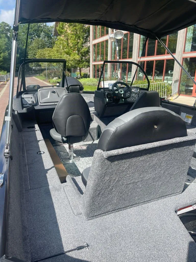 Slide: The Image of 2025 Tracker Pro Guide V-175 Combo boat interior with seating and steering wheel. - 3